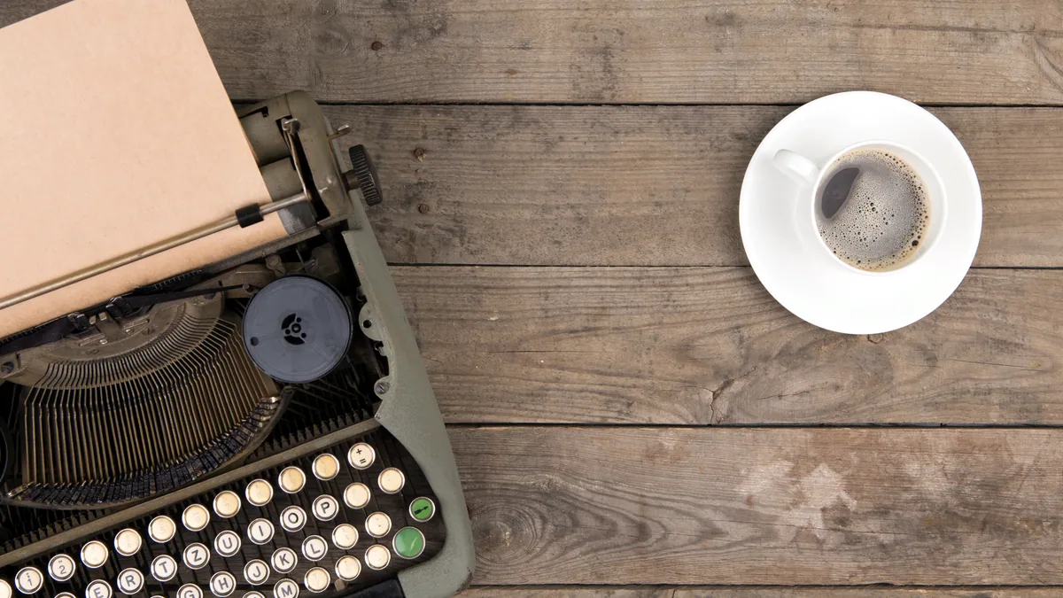 A well-worn typewriter with a sheet of paper, the machine of pulp writers.